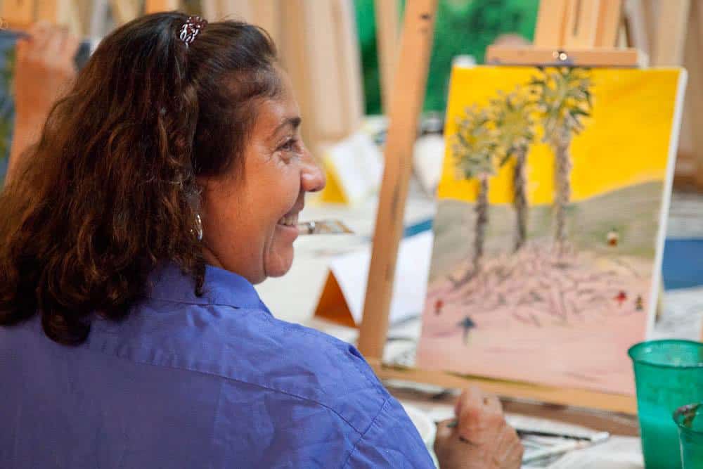 Artist smiling during class at My Favorite Art Place.