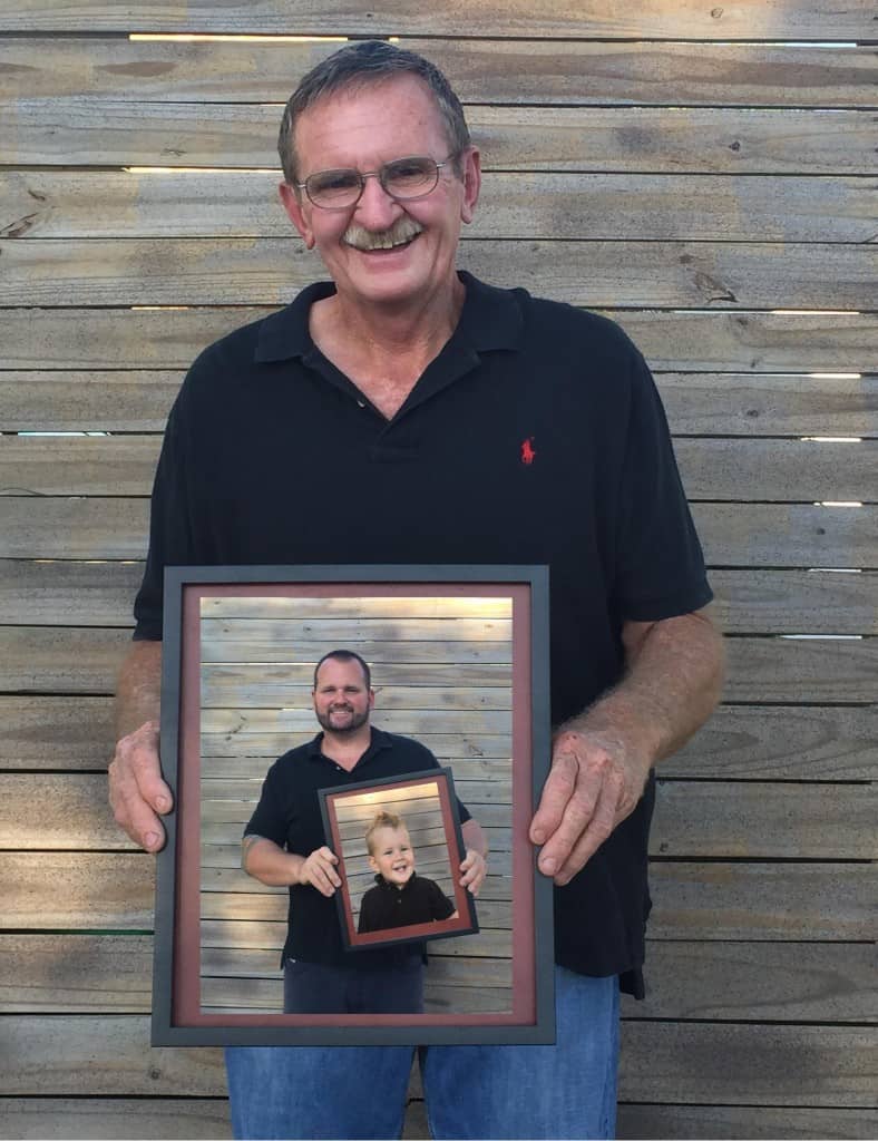 Man holding custom framed photo by My Favorite Art Place for family keepsakes