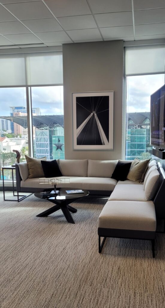 Office interior featuring layered framed art display by My Favorite Art Place